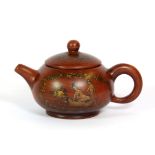 A small Chinese Yixing teapot gilt decorated with erotic scenes, H. 7.5cm.