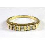 A 14ct yellow gold (stamped 14k) half eternity ring set with baguette and brilliant cut diamonds (
