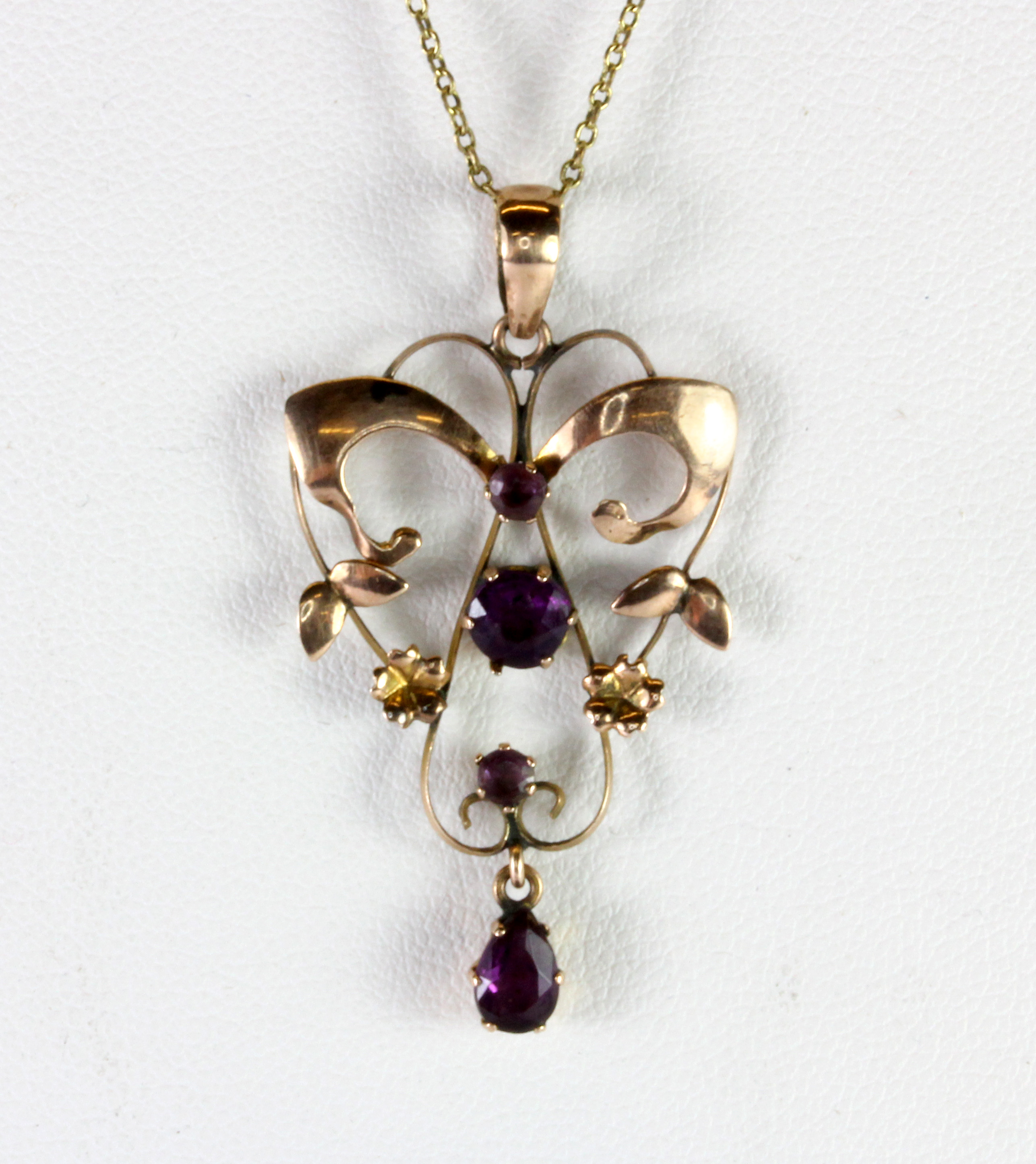 An Edwardian 9ct rose gold (stamped 9ct) amethyst set pendant on a later yellow metal (tested