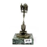 An interesting silver plated model of a Spanish water fountain on a green marble base, H. 22cm.