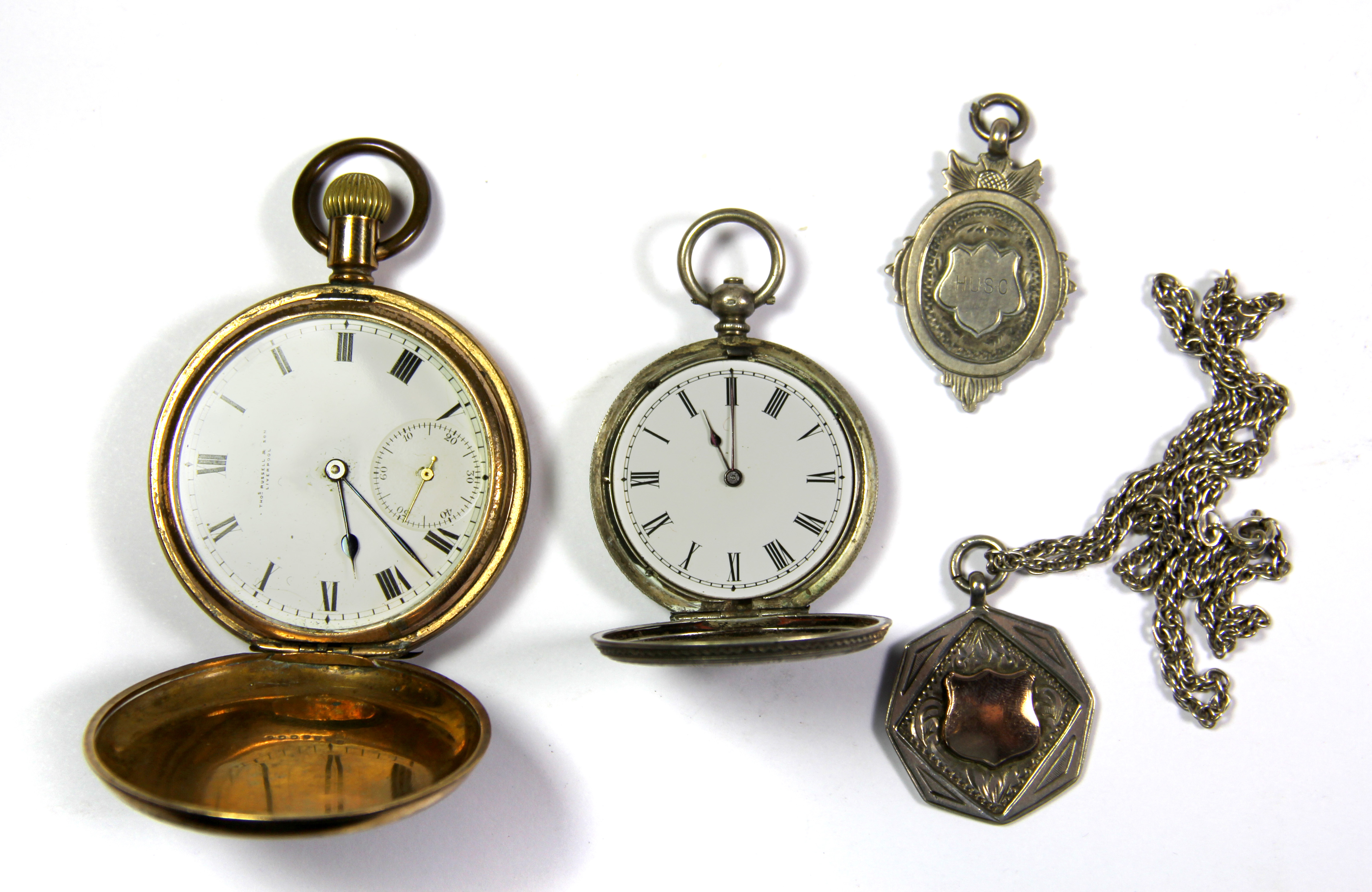 An 800 silver pocket watch with two silver fobs and chain and a further gold plated pocket watch.