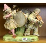 A large continental porcelain figure of two children playing music, H. 27cm