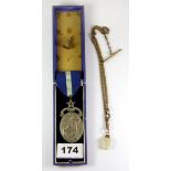 A silver Masonic medal with a gilt watch chain and two fobs.