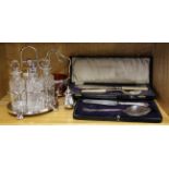 A four bottle silver plate cruet, two cased serving sets and two other items.