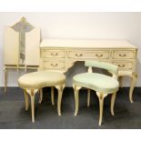 A 1960's painted and gilt dressing table with three way mirror and two stools.