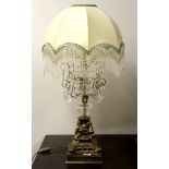 An impressive gilt brass and crystal table lamp with beaded shade, H. 83cm.