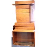 A set of 1970's wall mounted teak study furniture, comprising glazed cabinets, drawers and drop