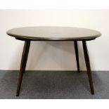 A 1960's Ercol coffee table, D. 74cm, H. 45cm.