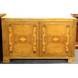 A similar burr veneered two door cabinet, W. 138cm x 93cm.