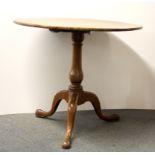 An early 19th century oak tilt top tea table, Dia. 83cm.