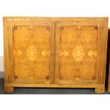 A good quality burr veneered two door cabinet fitted with shelves, W. 138cm, H. 110cm.