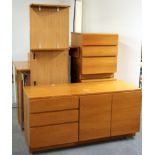 A set of 1970's teak study furniture including a cabinet, two chests of drawers, floating desk and