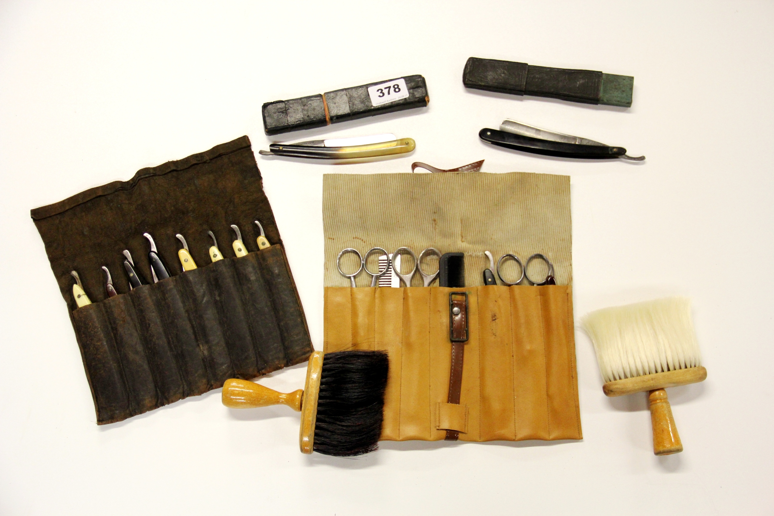 A vintage hairdressing kit including a case of razors.