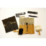 A vintage hairdressing kit including a case of razors.