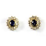 A pair of 18ct yellow gold (stamped 18k) sapphire and diamond cluster earrings.