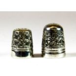 A white metal thimble (stamped C.H for Charles Horner) together with a further white metal thimble.