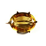 A yellow metal (tested 14ct gold) citrine set brooch, L. 2.3cm.