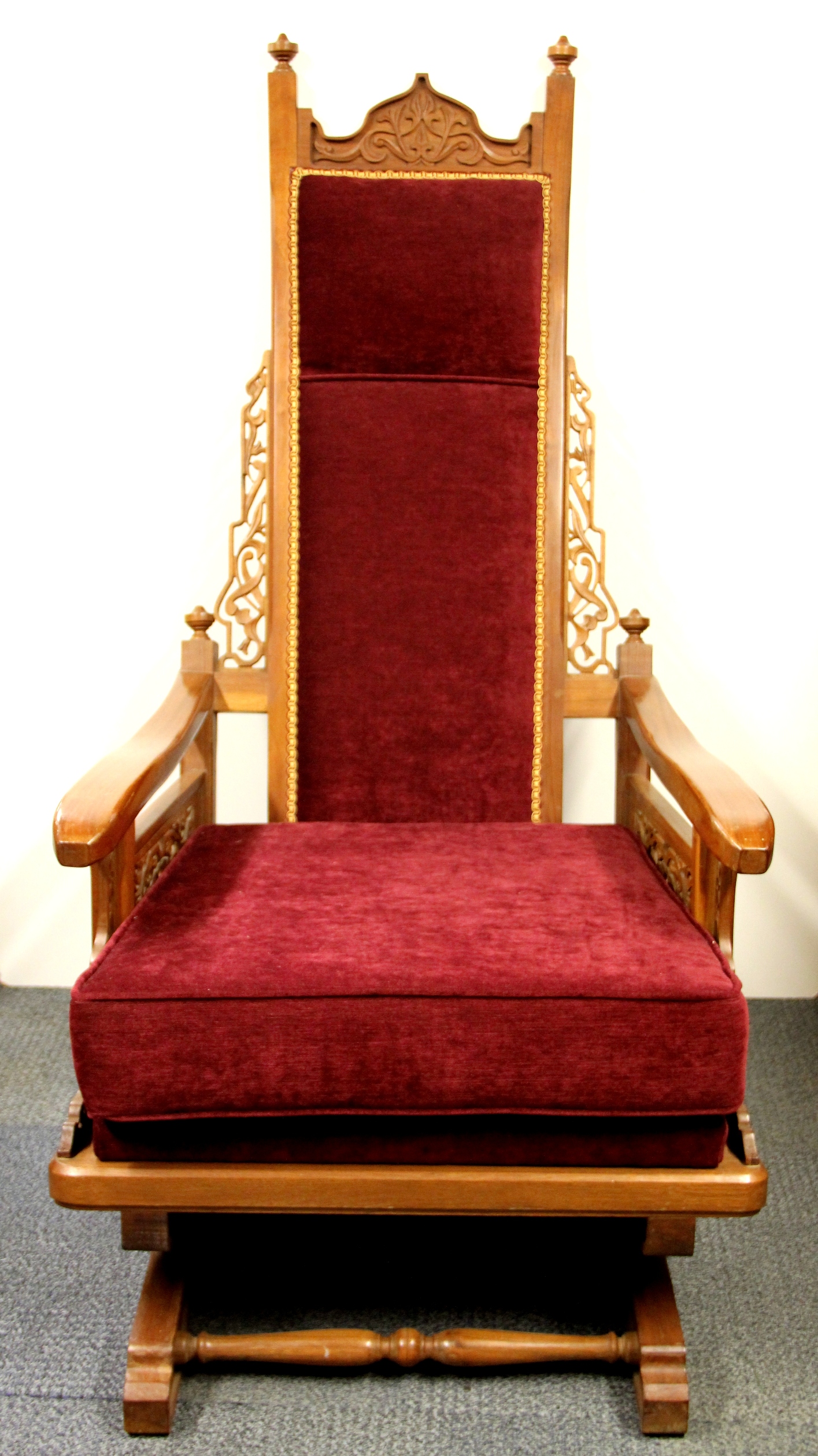 An early 20th century American Colonial carved rocking chair, H. 131cm.