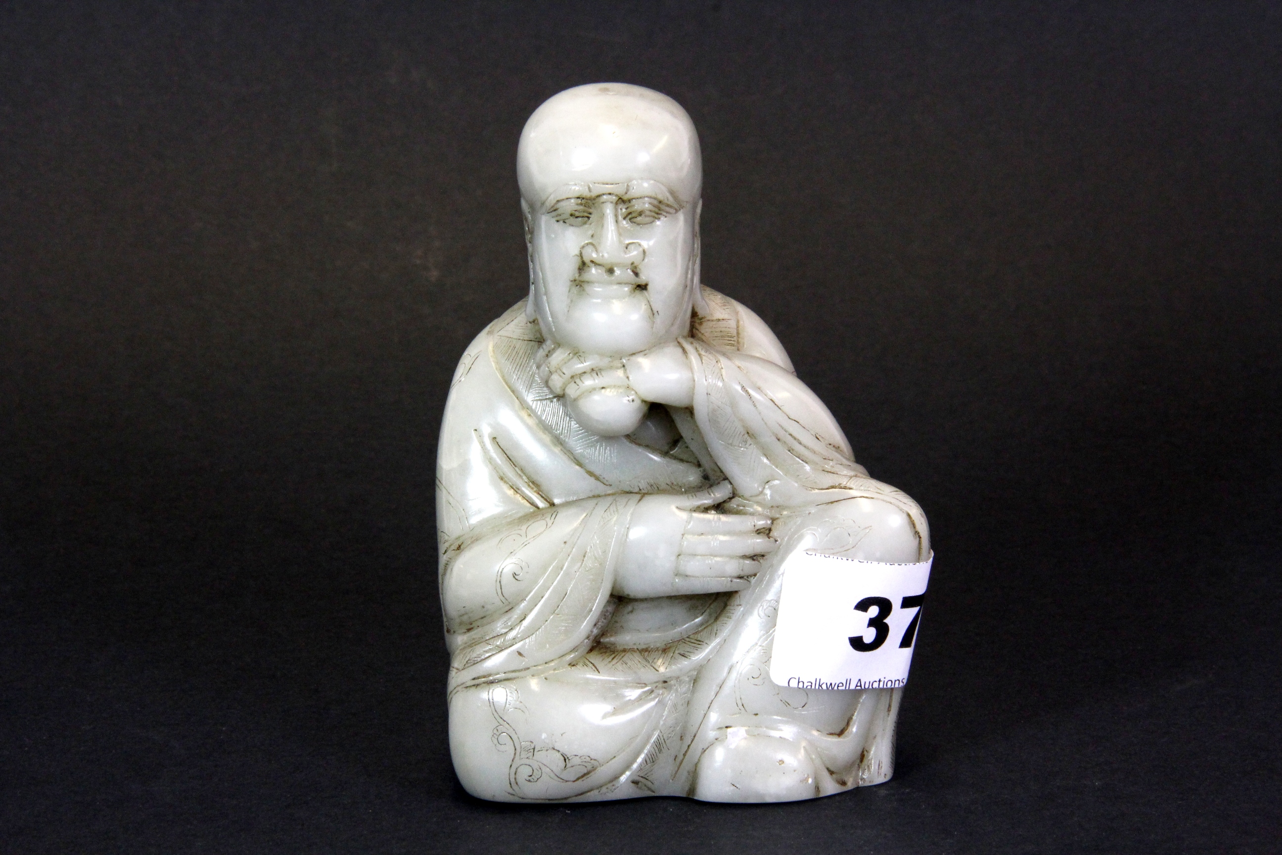 An interesting Chinese carved soapstone figural seal of a Lohan, H. 11.5cms.