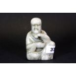 An interesting Chinese carved soapstone figural seal of a Lohan, H. 11.5cms.