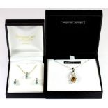 A 925 silver suite of pair of earrings and pendant set with white and blue topaz, together with a