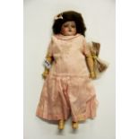 An antique Schoenau Hoffmeister 1909 porcelain head doll with articulated wood and composition body,