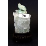 An unusual Chinese carved fluorite crystal jar and cover, on a carved wooden base, H. 14cms.