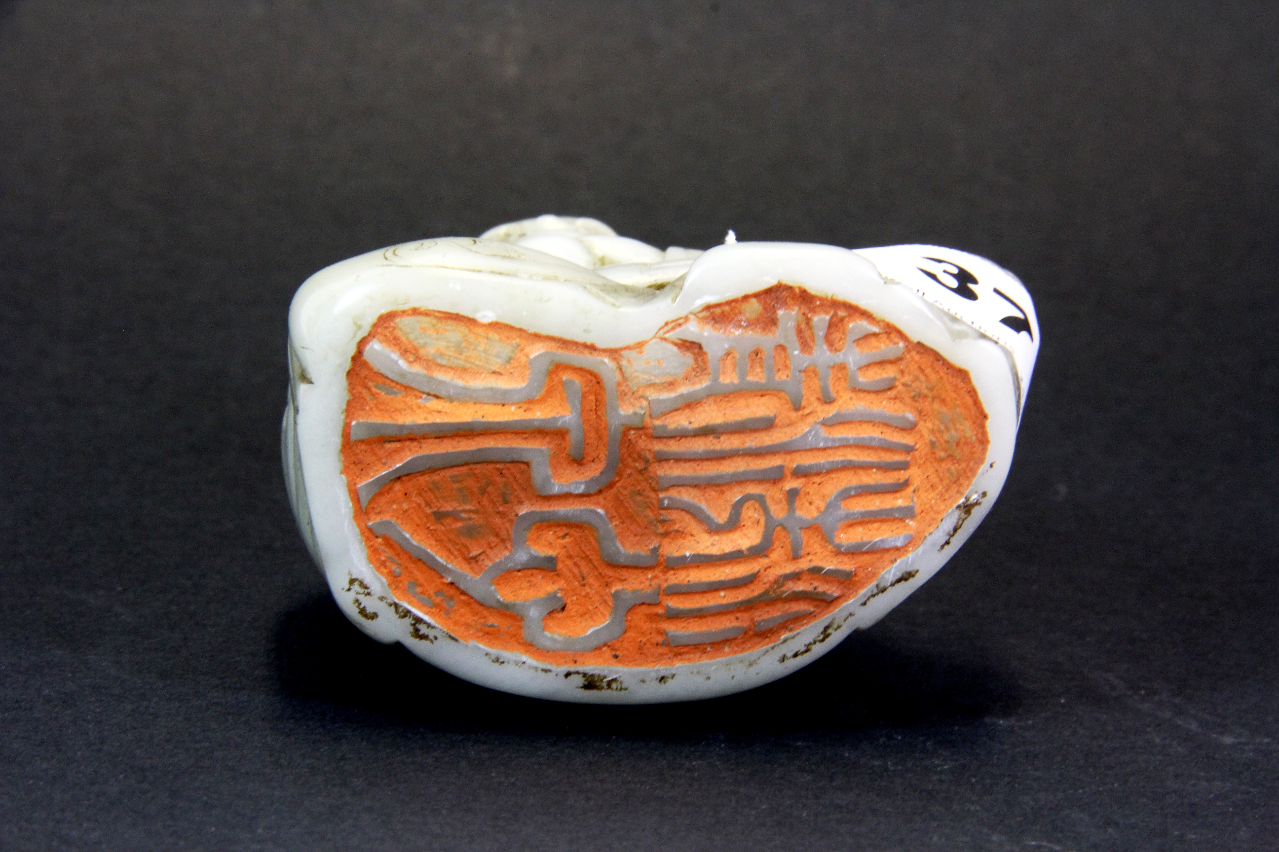 An interesting Chinese carved soapstone figural seal of a Lohan, H. 11.5cms. - Image 4 of 4