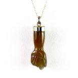 A 925 silver mounted carved agate fist shaped pendant and chain.