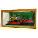 A large oak and glass cased horizontal steam engine operated with an electric motor. Case size 80