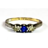 A yellow gold and silver (worn stamps) "below stairs" three stone ring set with blue and white