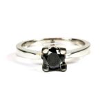 A heavy 18ct white gold (stamped 750) solitaire ring set with a brilliant cut black diamond, (