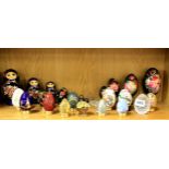 A set of Russian hand painted wooden dolls, with a set of hand painted eggs and a further collection