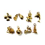 A quantity of 9ct yellow gold charms, (approx. 10.7gr).