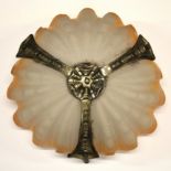 An Art Deco orange tinged Odeon type shell ceiling shade.