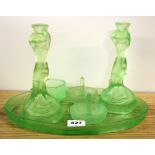 An Art Deco green glass dressing table set.