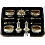 A hallmarked silver cased seven piece cruet set.