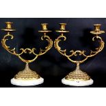 A pair of gilt metal and grey marble candelabra, H. 30cms.