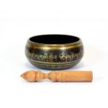 A Tibetan bronze singing bowl, Dia. 13cms.