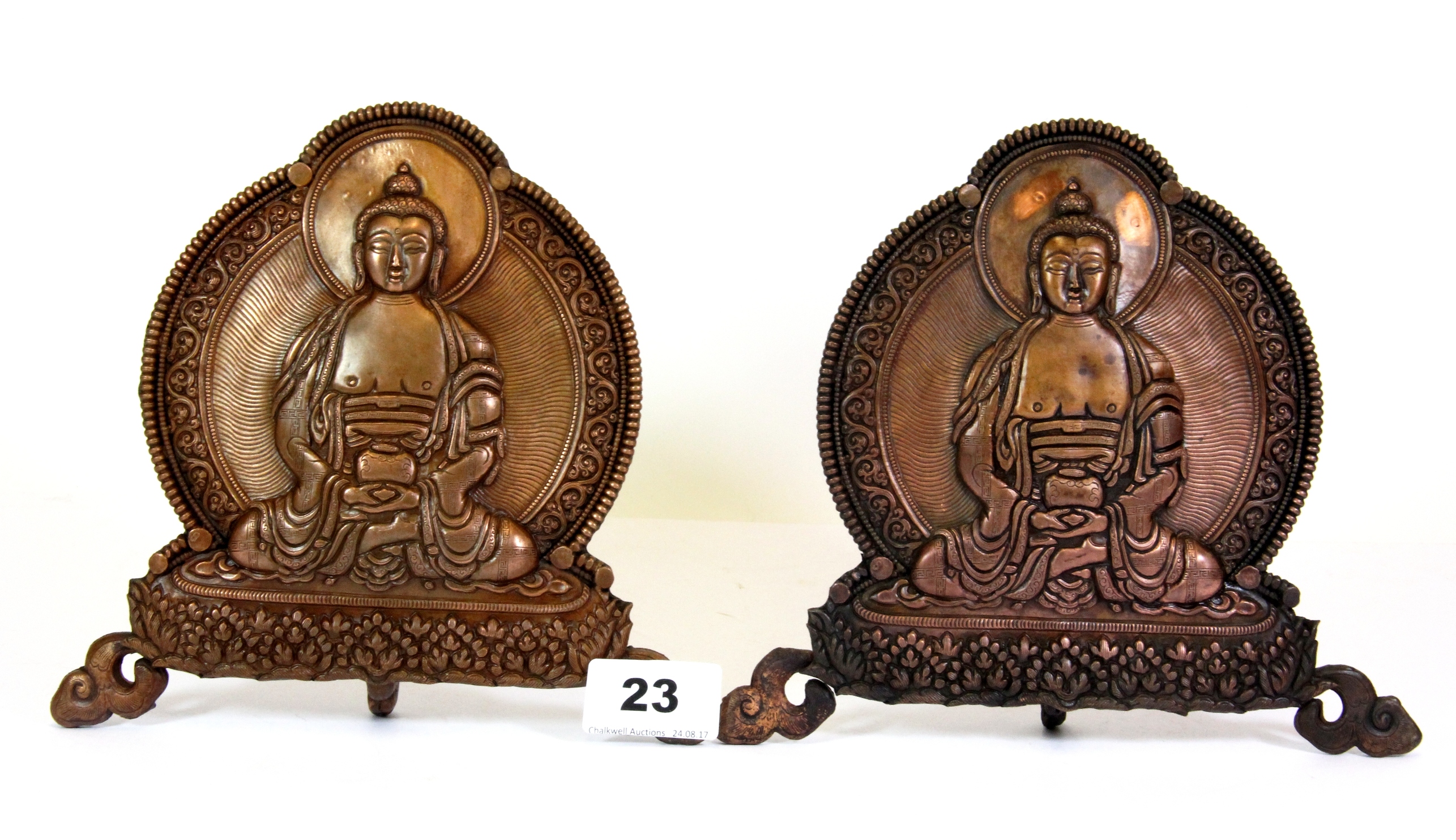 A pair of Tibetan hammered copper home shrine figures of a seated Buddha, H.17cms