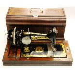 A cased early 20th century Frister and Rossmann hand sewing machine.