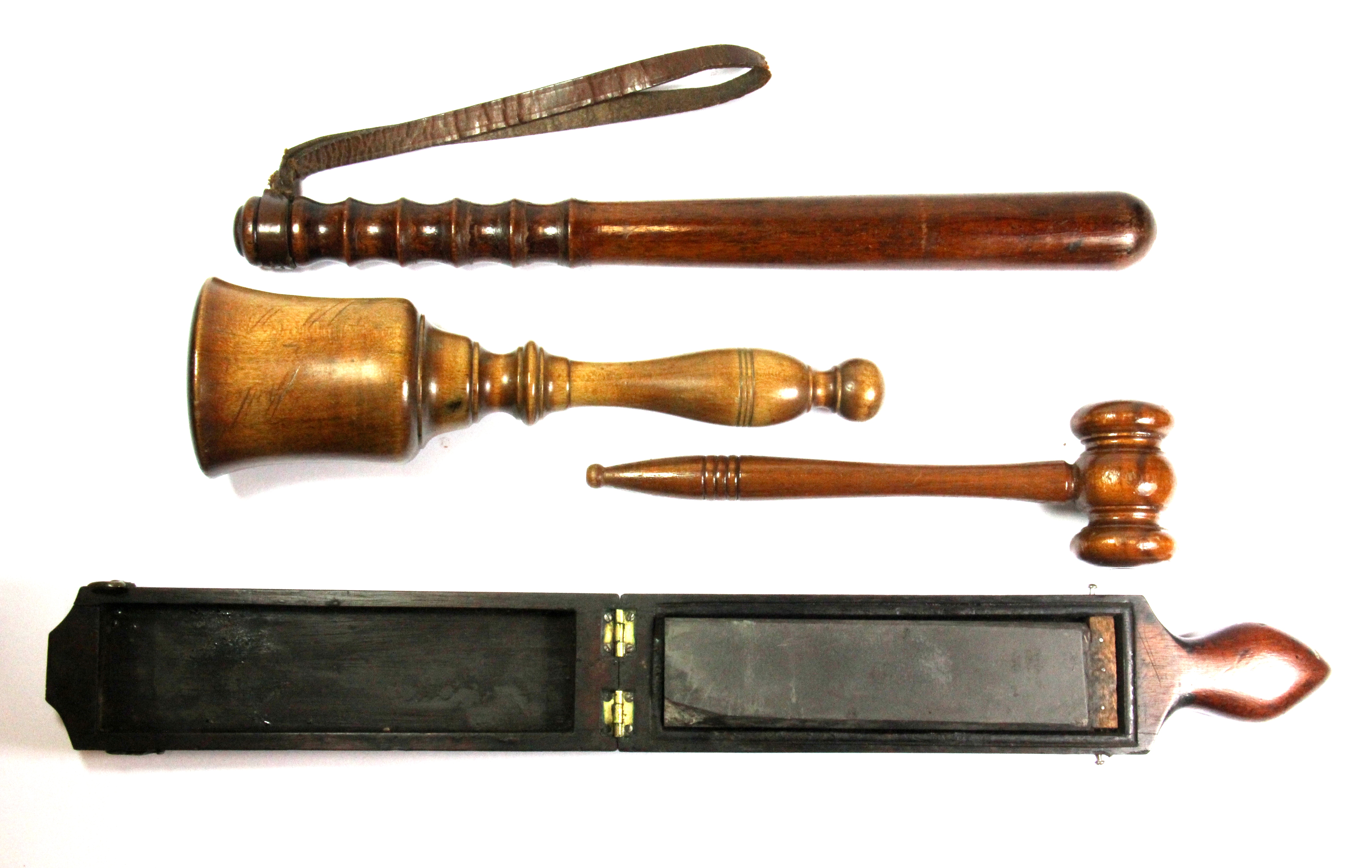 A collection of four interesting wooden items, including a trunchen, razor sharpener and two