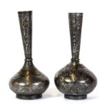 Islamic interest, two small Persian damascene decorated metal vases, H. 10cms.