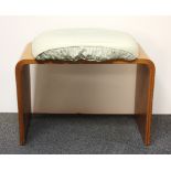 A 1960's wooden laminate dressing table stool with fixed cushion, W. 58cms H. 42cms.