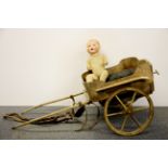 An early 20th century wooden dog cart, L. 102cms W. 51cms H. 43cms together with a porcelain head