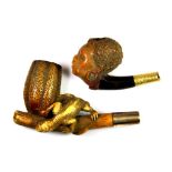 Two 19th century yellow metal mounted Meerschaum pipes of a Negro woman's head, H. 5cms, and a Gecko