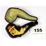 An interesting 19th century cased lady's Meerschaum pipe of a hand holding a crown, L. 9cms.