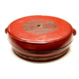 A mid 20th century Chinese red lacquered wooden circular moon cake box, W. 63cms.