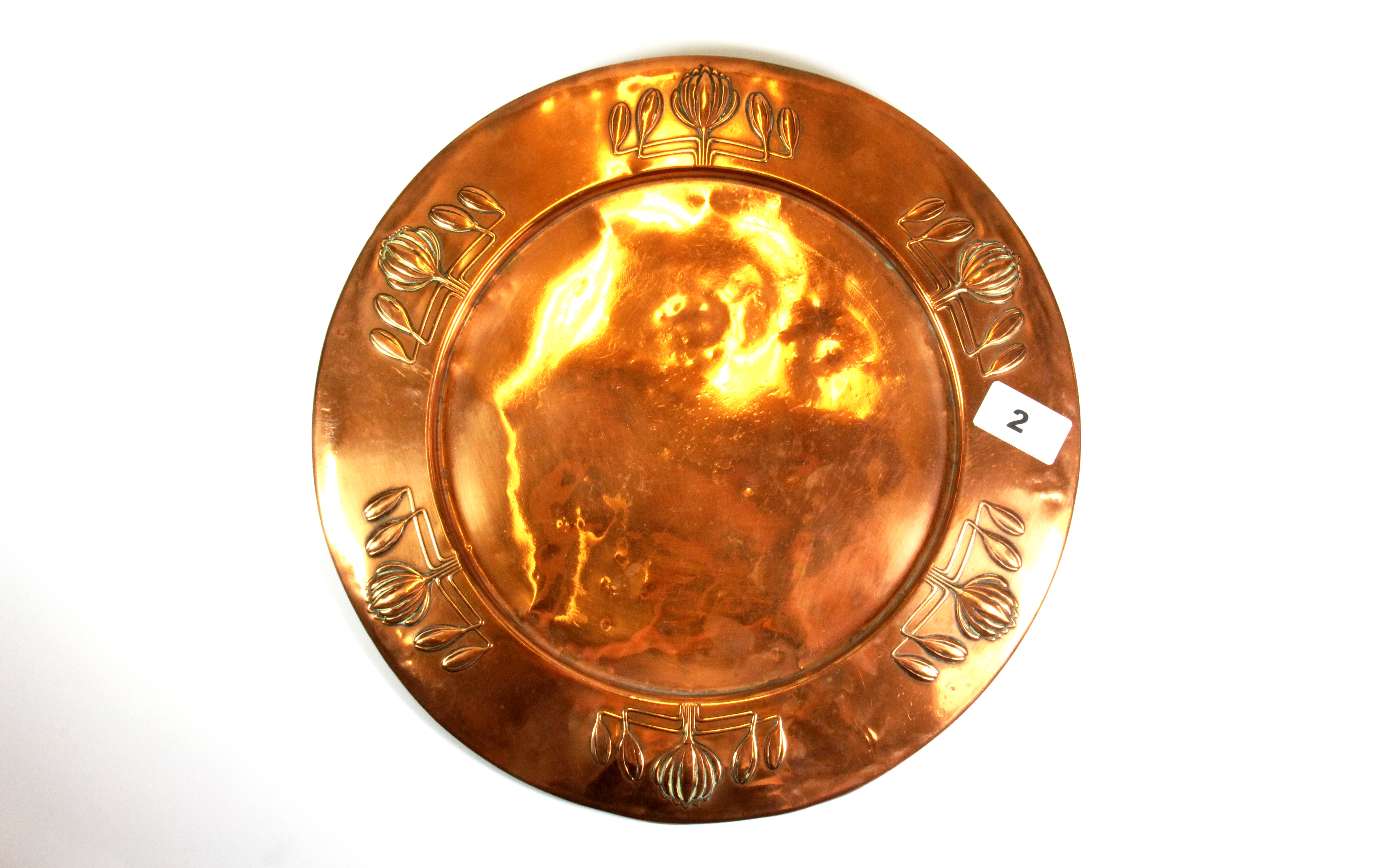 An Art Nouveau hammer copper platter stamped on the reverse for Carl Deffner, Dia. 32.5cms.