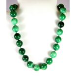 A jade bead necklace, L. 23cm.